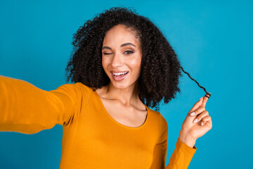 Photo portrait of nice young lady take selfie photo hold hair strand wink dressed stylish yellow...