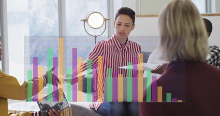 Image of data processing over diverse business people discussing in office