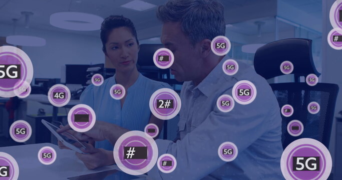Image of 5g text and data processing over diverse business people using tablet - Powered by Adobe