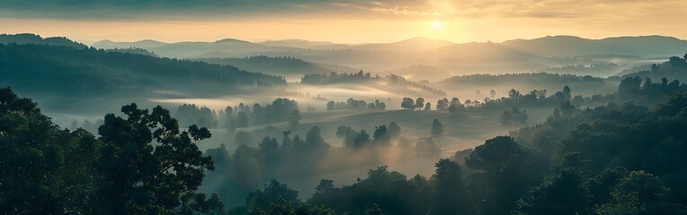 Aerial view of misty mountains at sunrise.