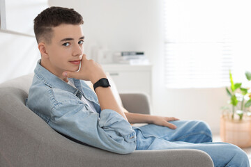 Obraz premium Portrait of teenage boy on sofa at home. Space for text