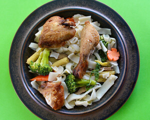 Crispy skin chicken with vegetables and rice noodles.