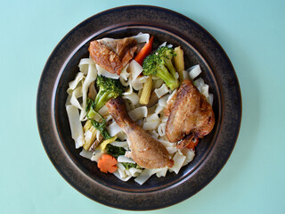 Crispy skin chicken with vegetables and rice noodles.