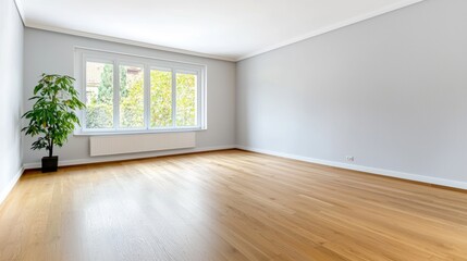 Obraz premium Empty living room with large windows and wooden floor. Concept of real estate, interior design, and open space.