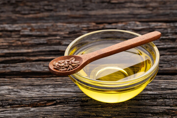 Linum usitatissimum - Organic flax seeds and oil in glass bowl