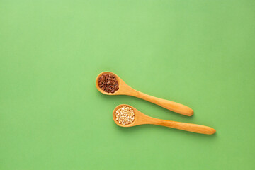 Organic quinoa and flax seeds in two spoons - Chenopodium quinoa and Linum usitatissimum.