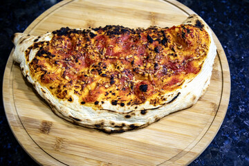 Traditional artisanal calzone made with long-matured dough stuffed with pepperoni and cheese