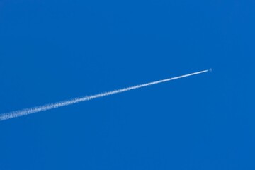 Contrail from an airplane in a cludless blue sky.