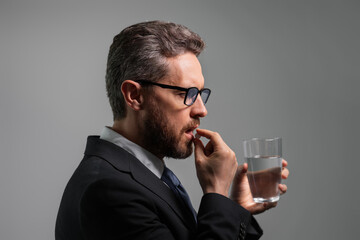Medicine pill from headache migraine. Headache, tiredness and stress. Business man in suit is tired got headache migraine. Headache pain concept. Painful men are stressed. Stressful and headache.