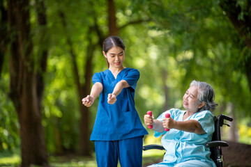 Healthcare or physical therapy nurse is helping elderly holding small dumbbells and appears engaged in an exercise routine caregiver individuals focused on rehabilitation exercises elder concept.