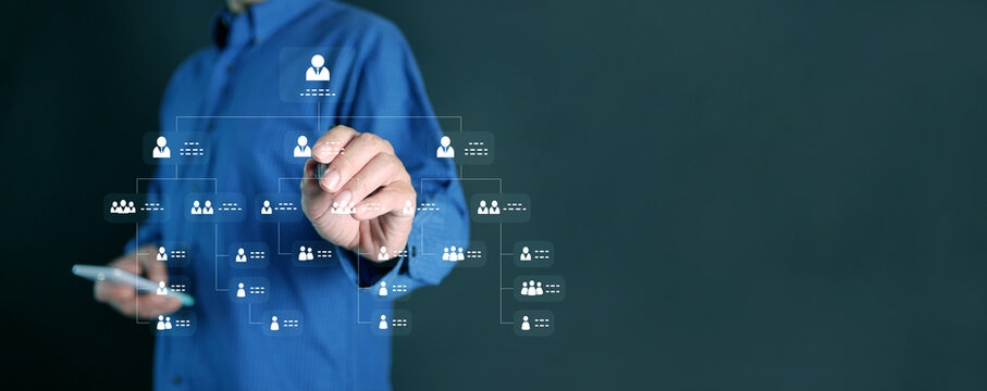 Hierarchy structure  concept. Businessman with a stylus tapping at organization chart as a virtual interface screen. Company or business hierarchical organizational chart of staff and employees