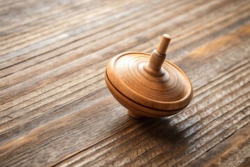Wooden spinning top spinning on ground, top view aerial shot