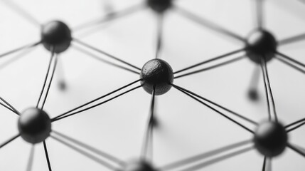 Abstract network of black spheres connected by black string, forming a grid pattern.