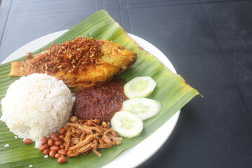 coconut rice with variety side meal such as fish chicken eggs meat and etc Nasi Lemak Berlauk