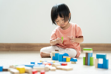 Happy Asian child playing and learning toy blocks. children are very happy and excited at home. child have a great time playing, activities, development, attention deficit hyperactivity disorder