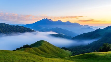 Fototapeta premium A high-definition image of a mountain landscape at sunrise with rolling hills and mist in the valley. The image features deep depth of field, with room for text in the glowing sky above the mountains.