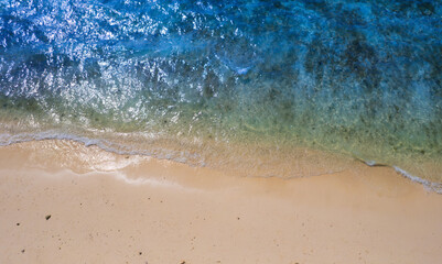 Top view beach sand background for summer vacation concept. Beach nature and summer seawater with sunlight light sandy beach Sparkling sea water