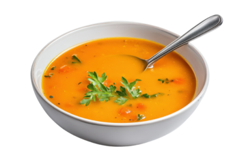 A warm bowl of delicious pumpkin soup garnished with fresh herbs, perfect for a cozy meal or autumn dinner.