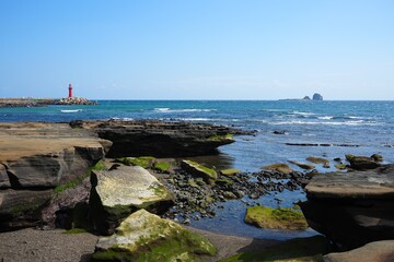 rock coast and lighthouse and island