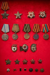 Naklejka premium A display of medals and awards on a red background