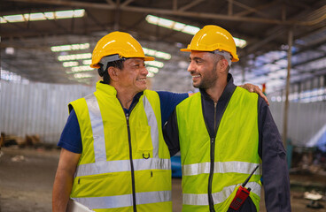 Two men wearing safety gear and smiling at the camera