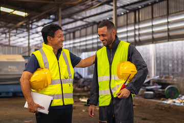 Two men in safety vests are smiling at each other