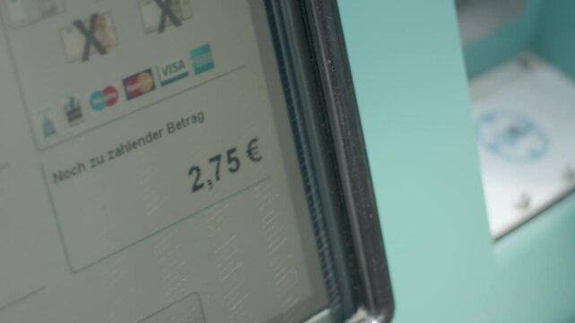 Close-up of a screen showing a decreasing amount to pay in euros