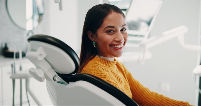 Dentist, happy and face of woman in chair for consulting, teeth whitening and wellness. Healthcare, dentistry and portrait of person with smile for dental hygiene, oral care and medical services