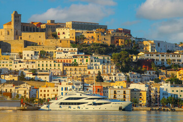 Naklejka premium Selective focus on building, beautiful Ibiza old town with blue Mediterranean sea and city view in the morning