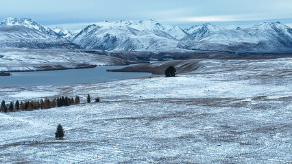 Drone perspective of snow covered agricultural land between Tekapo and pukaki