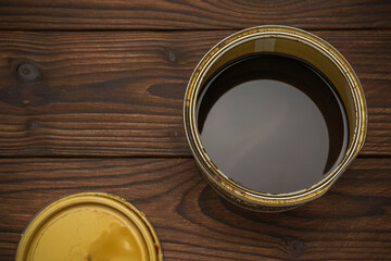 Open Paint Can on Dark Wooden Floor - Home Renovation and DIY Concept
