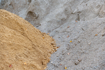 A pile of yellow and white sand, ready for construction or landscaping work