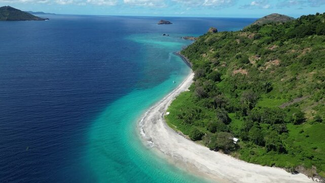 drone fly above white sand beach strip of coastline in Comoros island Indian Ocean marina national park travel destination