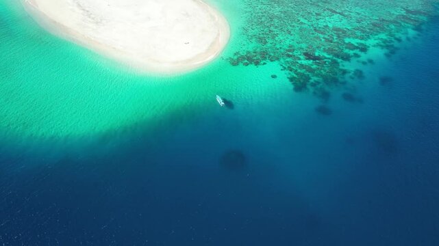 drone approach a lonely boat moored in little islet in Union of the Comoros, the Moh&eacute;li island marine National Park