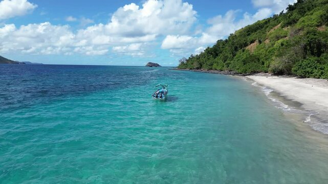 private white sand beach in the middle of the indian ocean with bright blue ocean water