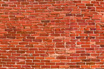A close-up image of a red brick wall with white mortar.