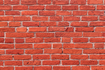 Close up of red brick wall with visible mortar.