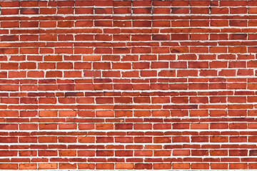 A close-up shot of a red brick wall with white mortar.