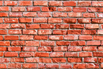 Close-up of a red brick wall with mortar.