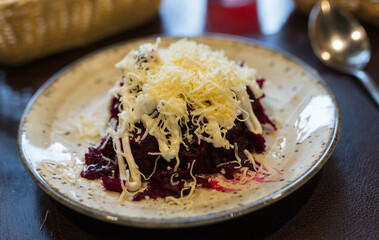 Grated boiled beets with garlic, cheese and mayonnaise