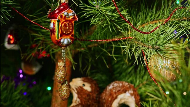 Clocks. Christmas tree, toy decorations. New Year and Merry Christmas. Smooth camera movement on the slider. Video postcard. Live christmas tree with garlands and toys