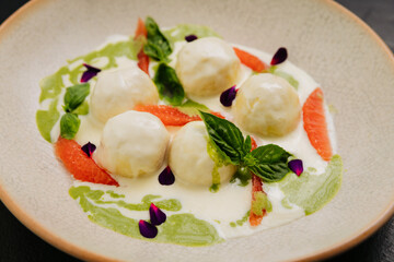 Gourmet cheese balls with herbs and citrus on an plate, perfect for culinary and food photography