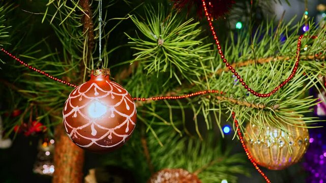 Pink ball. Christmas tree, toy decorations. New Year and Merry Christmas. Smooth camera movement on the slider. Video postcard. Live christmas tree with garlands and toys