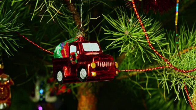 Santa Claus red car with presents. Christmas tree, toy decorations. New Year and Merry Christmas. Smooth camera movement on the slider. Video postcard. Live christmas tree with garlands and toys