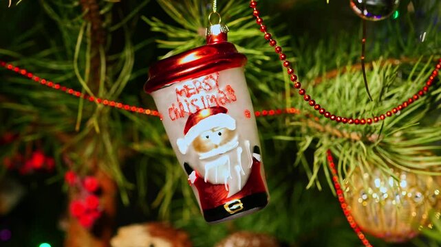 Cup. Christmas tree, toy decorations. New Year and Merry Christmas. Smooth camera movement on the slider. Video postcard. Live christmas tree with garlands and toys