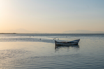 Fishermans boats in the Karina region near the Soke district of Aydin province Turkey are warmed by sunlight at sunrise