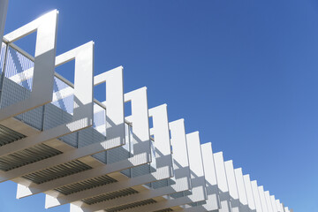 Fototapeta premium white metal structure of a flyover with a blue sky background