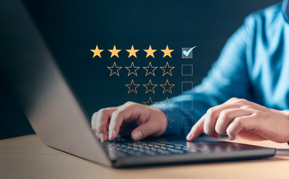 result, review, satisfaction, survey, star, excellent, rate, ranking, feedback, report. A laptop with a man typing on it and a star rating system.