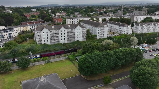 Steam Train, Monkstown, County Dublin, Ireland, September 2024. Drone follows the Dublin Riviera Express pulled by No.131 Steam Locomotive passing Salthill with D&uacute;n Laoghaire in the background.