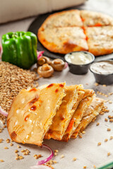 Whole wheat stuffed naan with barley and ingredients in the background.
